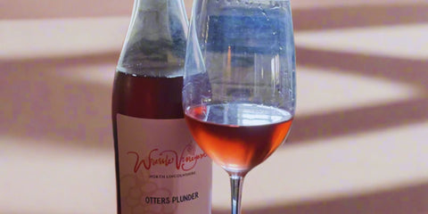 Bottle of Wressle Vineyard's Otters Plunder and a glass for wine tasting