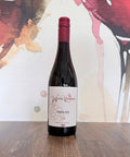 Bottle of Foxed Red 2025 English Pinot Noir from Wressle Vineyard, North Lincolnshire, with a cream label and burgundy cap, standing on a wooden table