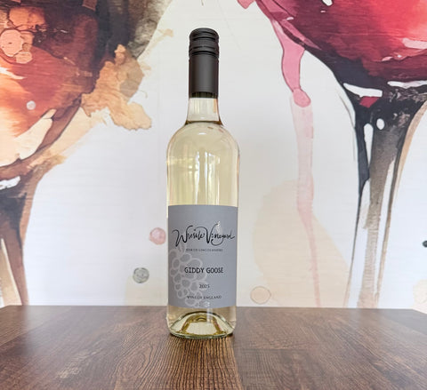 Bottle of Giddy Goose 2025 English white wine from Wressle Vineyard, North Lincolnshire, with a grey label, standing on a wooden table