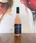 Bottle of Holy Moley 2025 Pinot Noir rosé from Wressle Vineyard, North Lincolnshire, with a dark navy label, standing on a wooden table