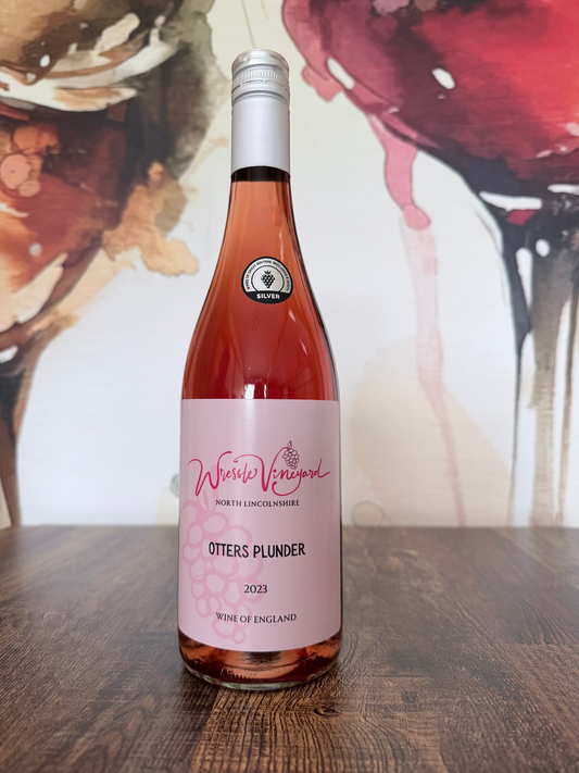 Bottle of Otters Plunder 2023 wine on a wooden surface with a colourful abstract background