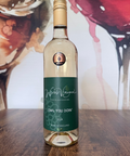 Wine bottle labelled 'Owl You Doin 2024' on a wooden surface with an abstract wine glass background