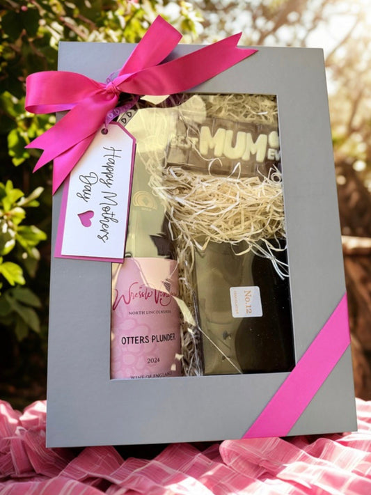 Mother's Day wine and chocolate gift set with pink ribbon and product tag, featuring a bottle and a box.