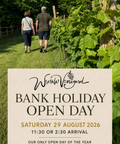 Promotional graphic for Wrestle Vineyard Bank Holiday Open Day, featuring a background photo of a couple walking along a grassy vineyard path with grapevines on the right, and a large beige text box at the bottom with event details and the Wrestle Vineyard logo.